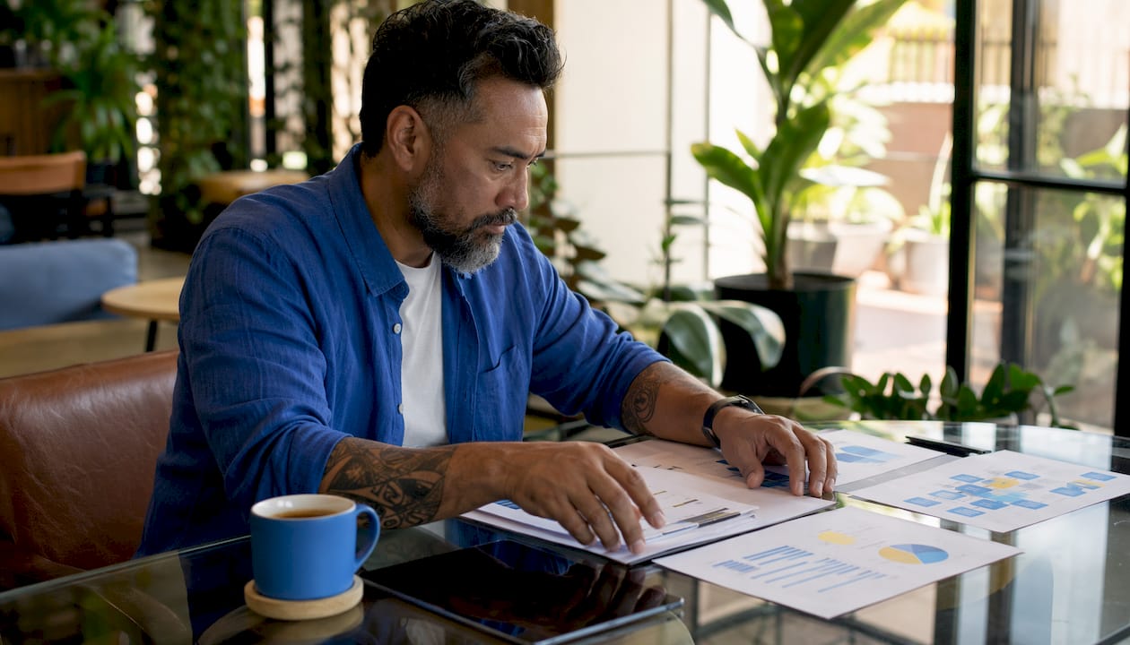 Hands organizing ecommerce marketing strategy documents