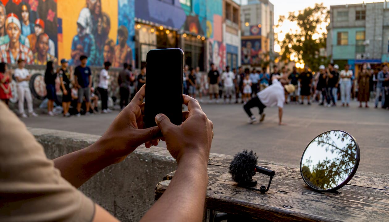 Hands filming vertical video on smartphone